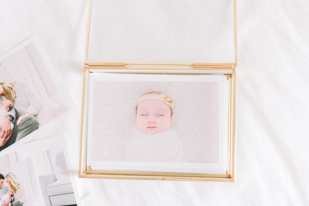 Brandon newborn photographer | Newborn session prints displayed nicely in a glass box. 