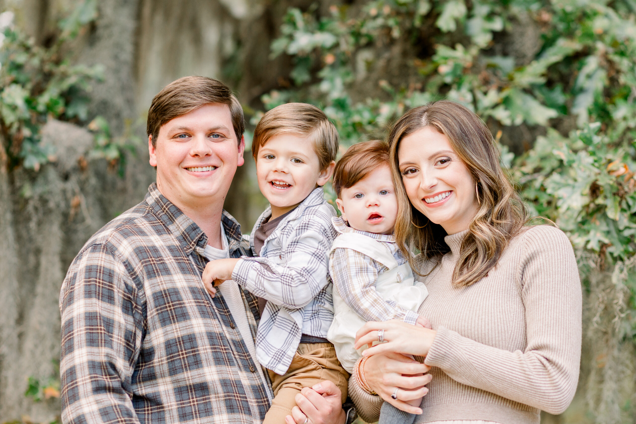 Family smiles at camera together for fall family photos by Mississippi family photographer, CJ and Olive Photography.