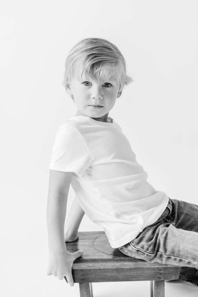 Little boy gives serious look for in studio session by CJ and Olive Photography, a Brandon Family Photographer for personality portraits. 