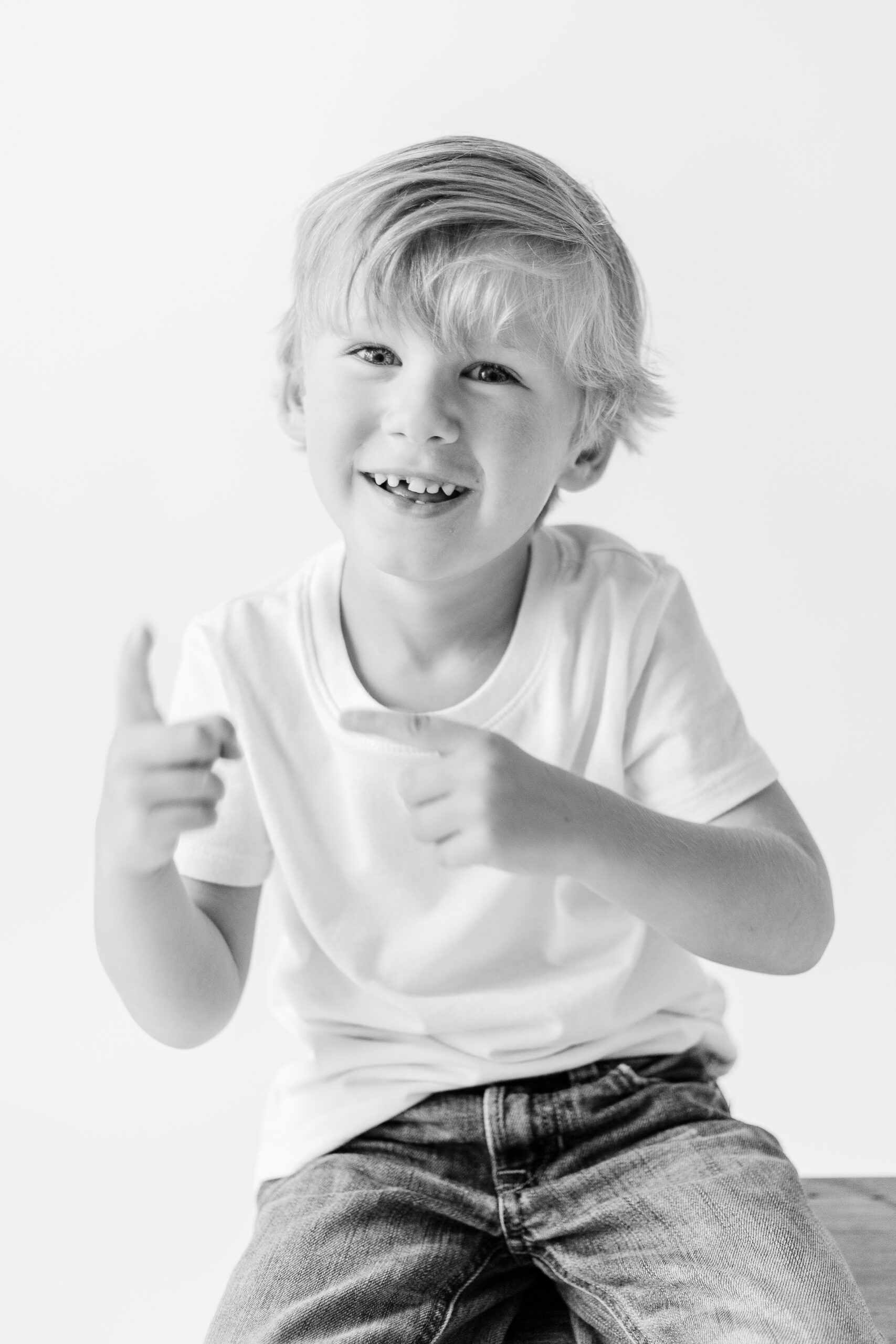 Little boy dances silly for in studio session for personality portraits by CJ and Olive Photography, a Brandon Family Photographer.